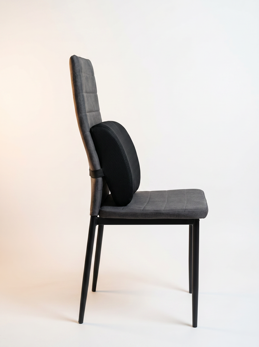 Coussin lombaire noir sur chaise, vue de côté, pour soutien du bas du dos en position assise